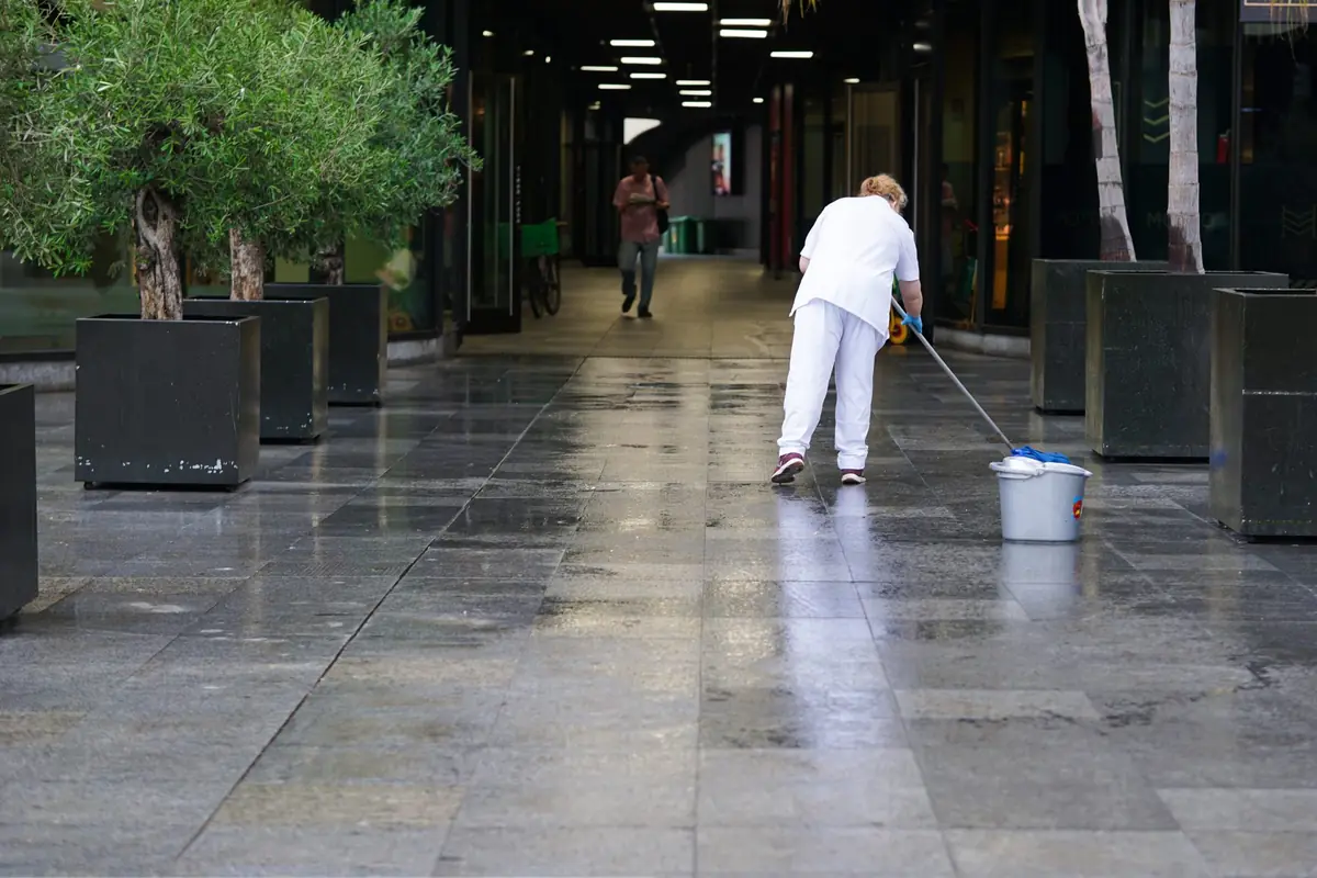 Janitor mopping the floor of a commercial building