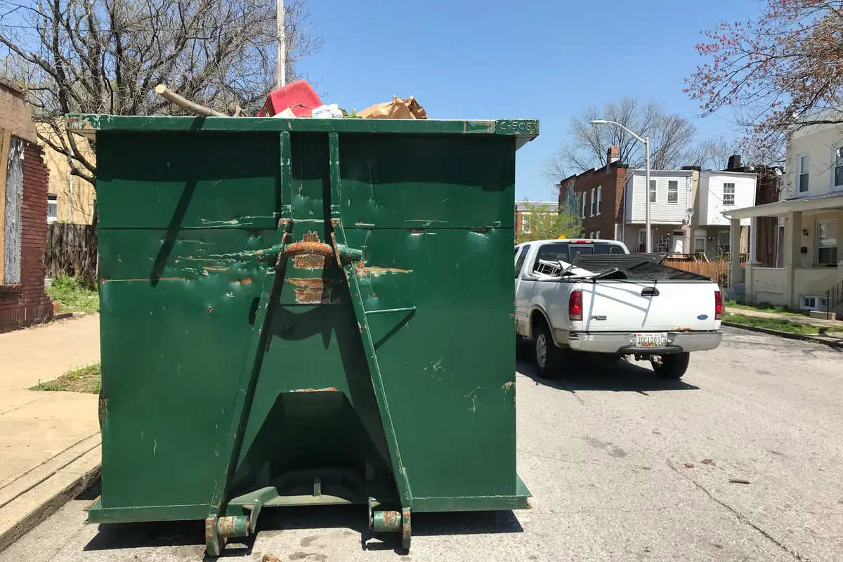 Dumpster loaded during a junk removal job